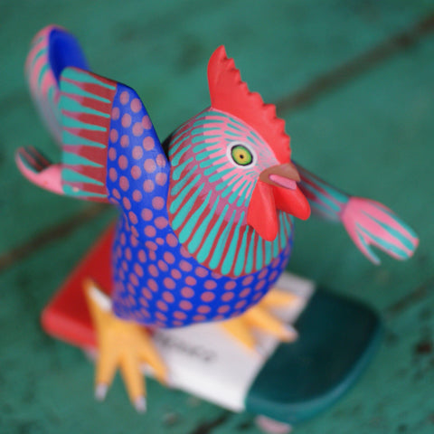 Carved and Painted Skateboard-Riding Roosters, Avelino Perez, La Unión Tejalápan Whimsical Zinnia Folk Arts Red on Blue/ "Mexico" on Skateboard