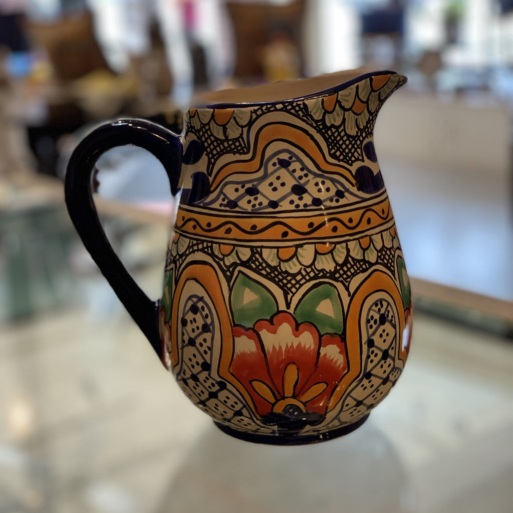 https://zinniafolkarts.com/cdn/shop/files/talavera-water-pitchers-various-designs-ceramics-zinnia-folk-arts-orange-hibiscus-721380_1024x1024.jpeg?v=1700148279